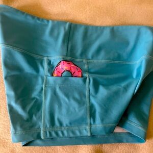 feed me fight me blue shorts with hidden donut in pocket